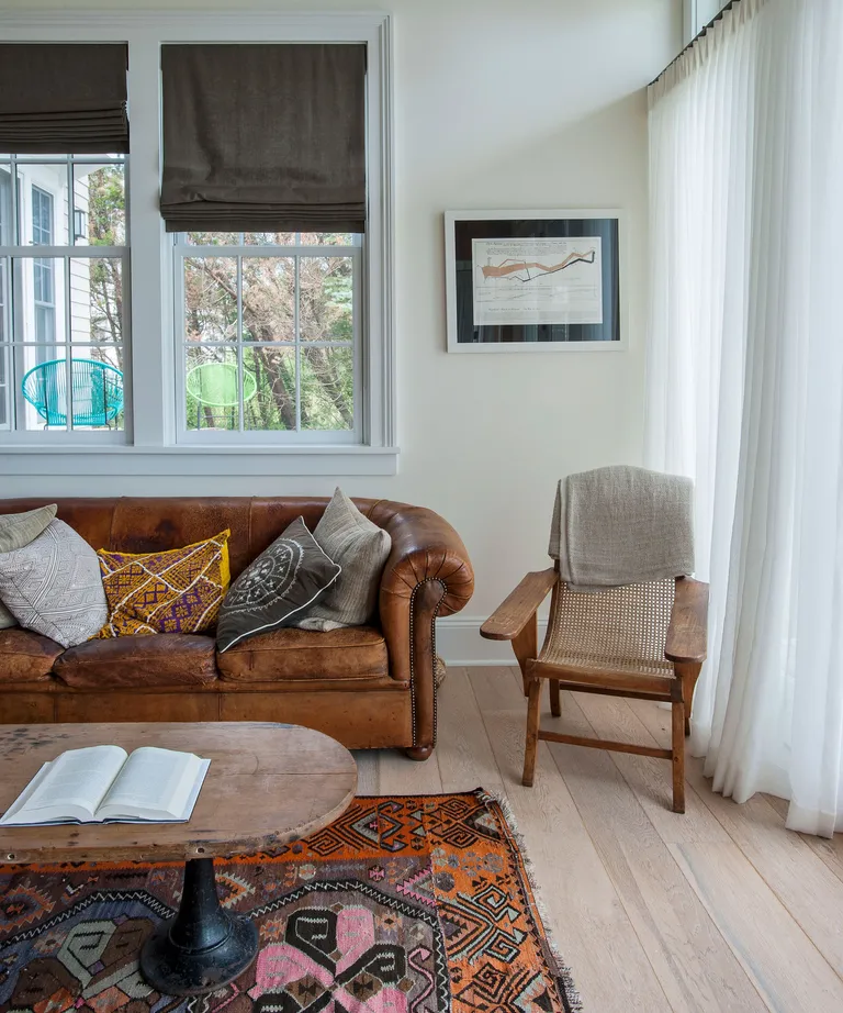Neutral living room with wood chair and leather sofa