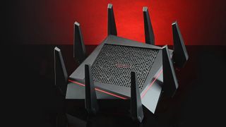 Wireless routers on a black surface in front of a red background