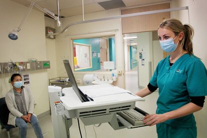 A doctor meets with a patient.