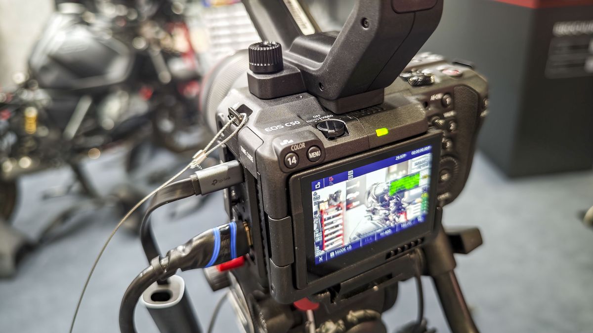 IBC 2025 show &ndash; Canon EOS C50 on a tripod with top handle attached and multiple extenral devices connected