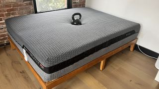 Layla Hybrid mattress with a weight in the centre to show sinkage