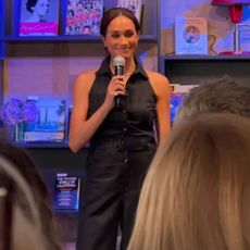 Meghan Markle in a sleeveless navy blue tuxedo jumpsuit from Club Monaco at bookstore in Santa Barbara.