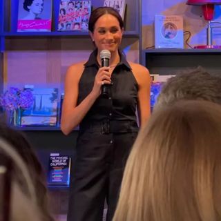 Meghan Markle in a sleeveless navy blue tuxedo jumpsuit from Club Monaco at bookstore in Santa Barbara.