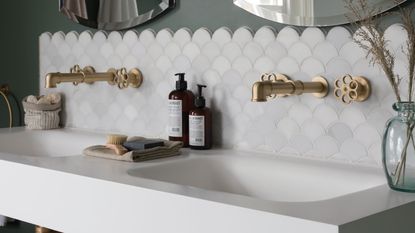 White scalloped tiles show space-boosting tricks you can use when choosing tiles for small bathrooms.