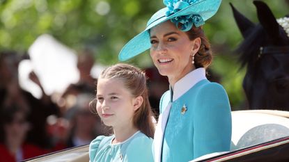 Princess Charlotte and Kate Middleton riding in a carriage during Trooping the Colour 2025