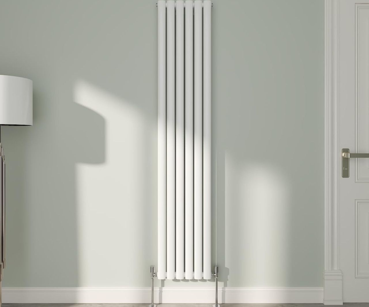 NRG White Oval Radiator Vertical on a green wall next to internal door