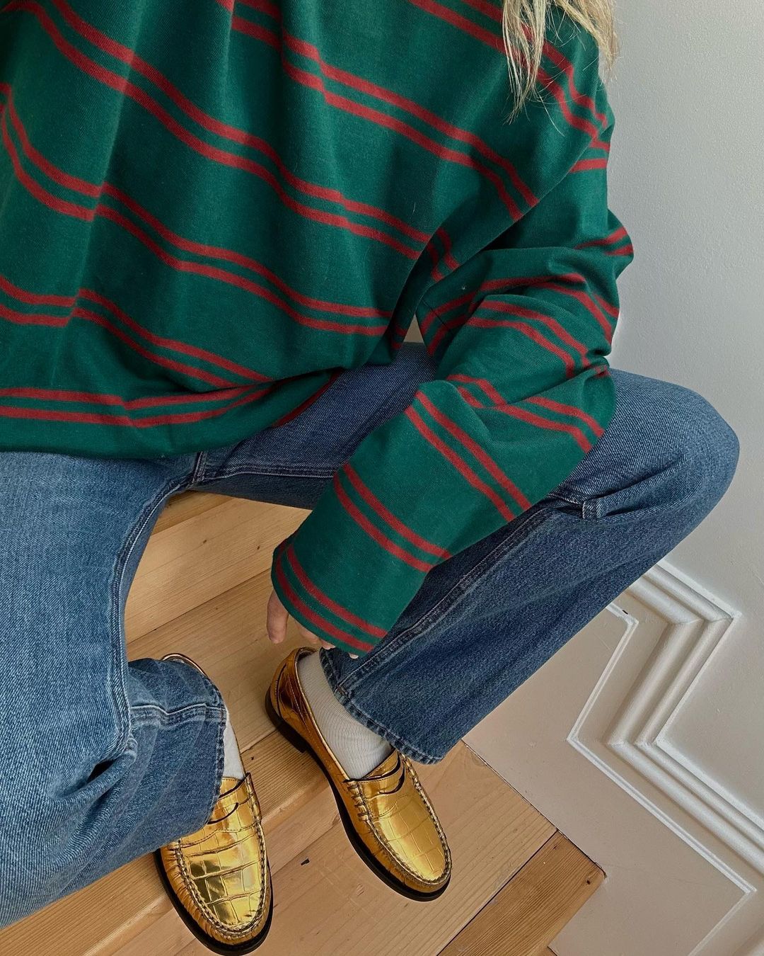 Lucy Williams wearing jeans and gold loafers