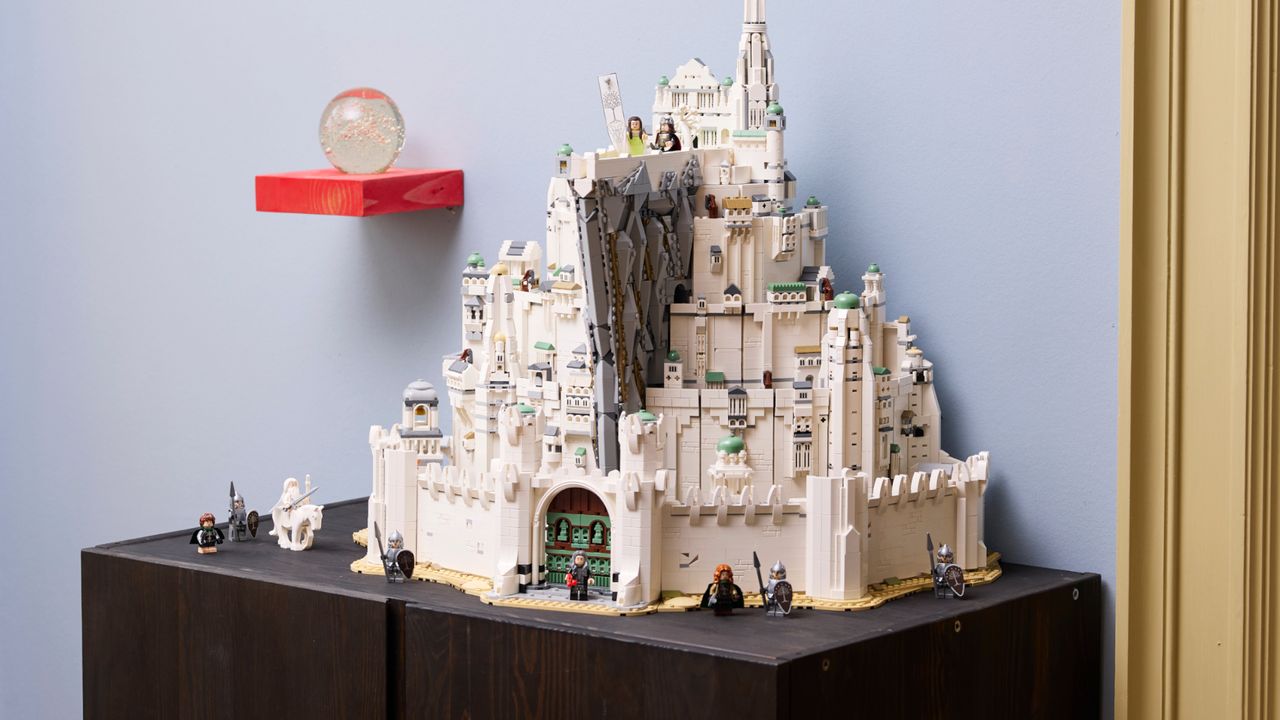 Lego Minas Tirith on a wooden surface, with multiple minifigures visible