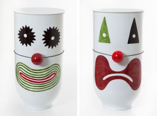 2 images of white charpin vases with 2 different painted on clown expressions , photographed against a white background