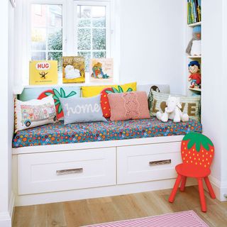 playroom with upholstered storage window seat