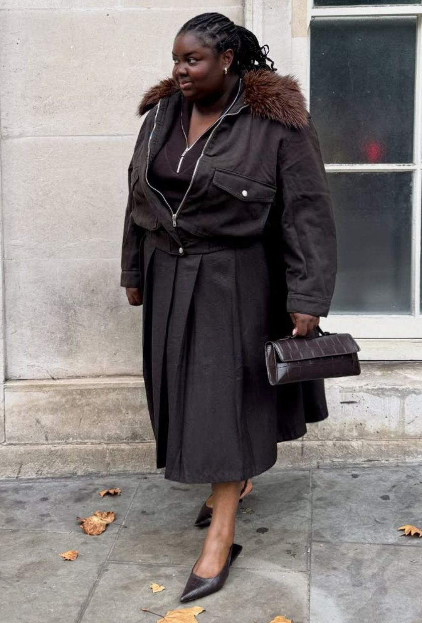 @abimarvel wears a brown faux-fur collar jacket, zip-up top, pleated midi skirt, low heel and a croc bag.