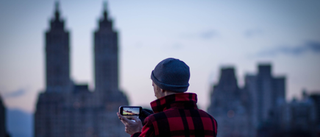 Man taking photo of city at a distance on his phone