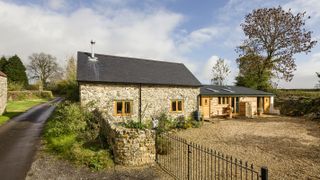 stone barn conversion with metal gates