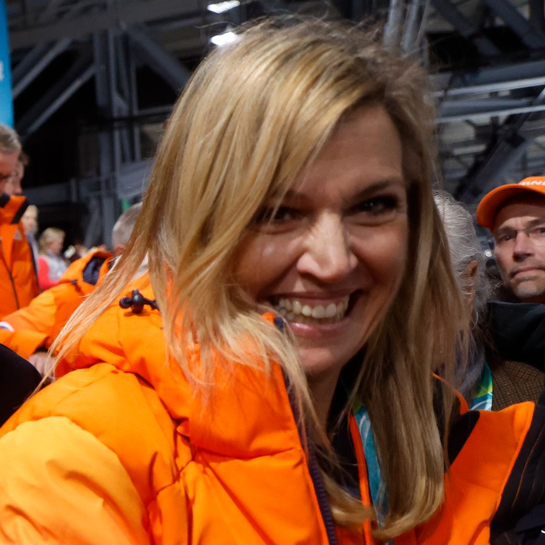 Queen Maxima wearing an orange puffer coat