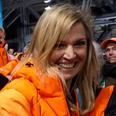 Queen Maxima wearing an orange puffer coat