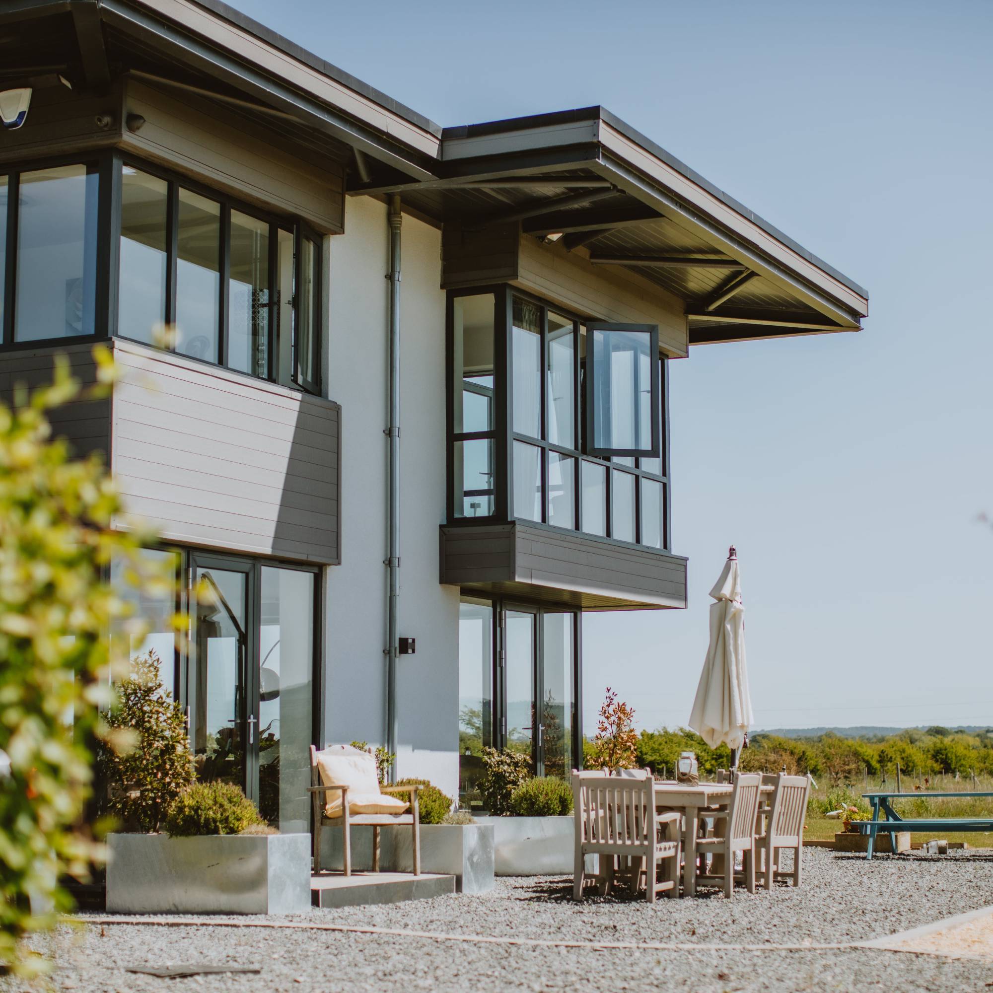 composite cladding on modern house with gravel garden and seating area