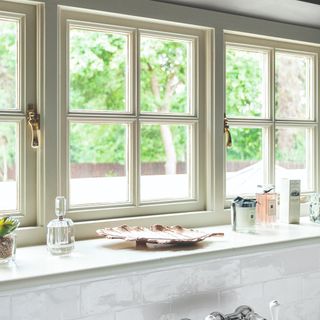 A bathroom window with scented candles