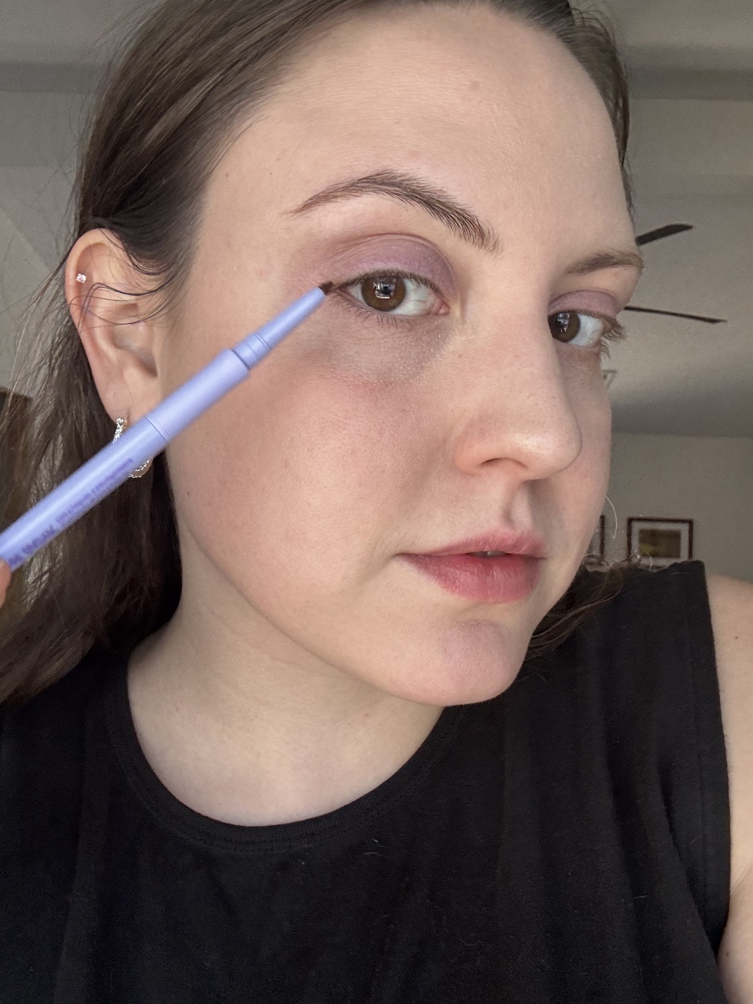 Sophia Vilensky applying Kosas eyeliner as part of her waterproof makeup routine.