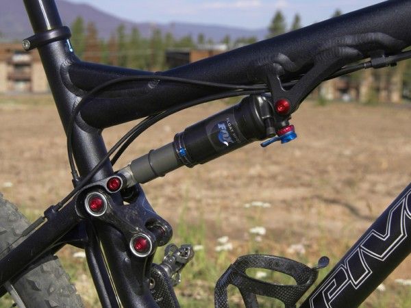 The upper link is carbon fibre and all of the pivot hardware is anodized aluminum. A Fox Racing Shox RP23 ties it all together