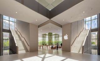The retail space at the Apple Store in Macau is flanked by two stone staircases, by Foster + Partners