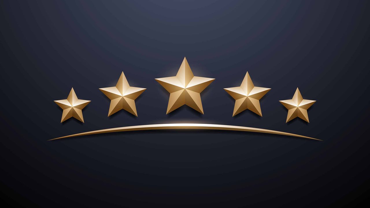 five gold stars on black background