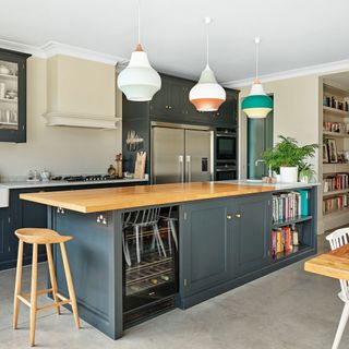 kitchen with central island and dark painted cabinetry painted with blue grey paint