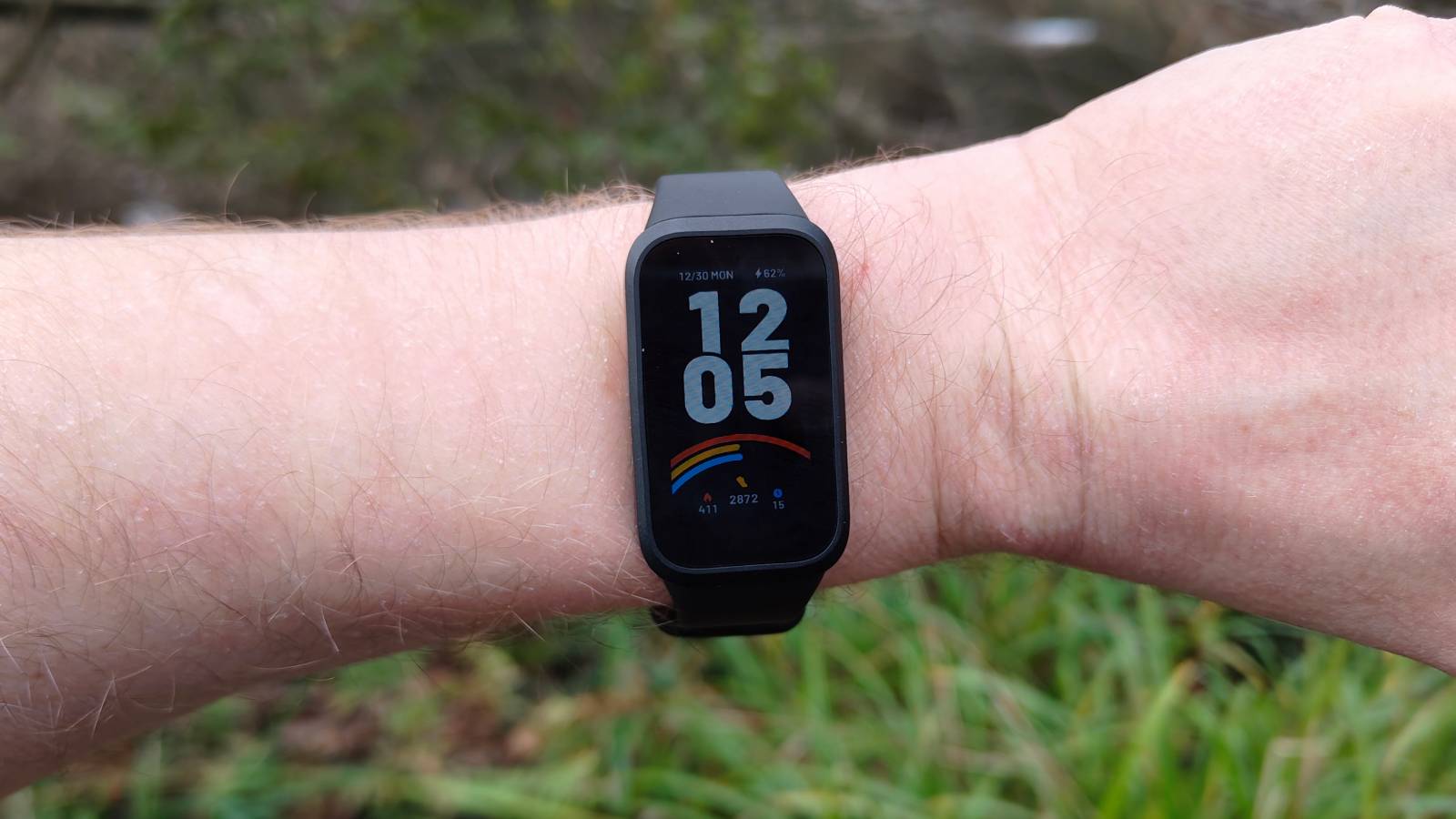 The Xiaomi Smart Band 9 Active being worn in a park.