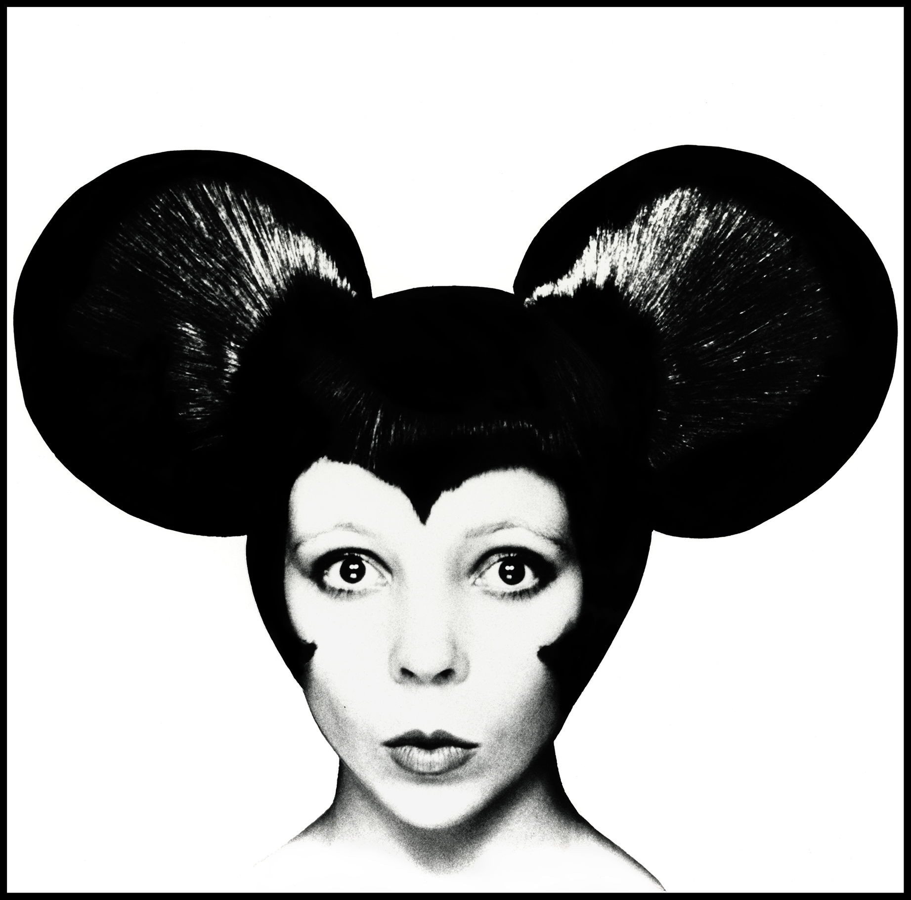 A black and white image of a person with large, round ears resembling mouse ears, set against a stark white background