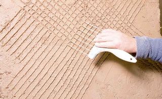 expert guide to plaster in old homes: Scratching the plaster so the next coat will adhere properly