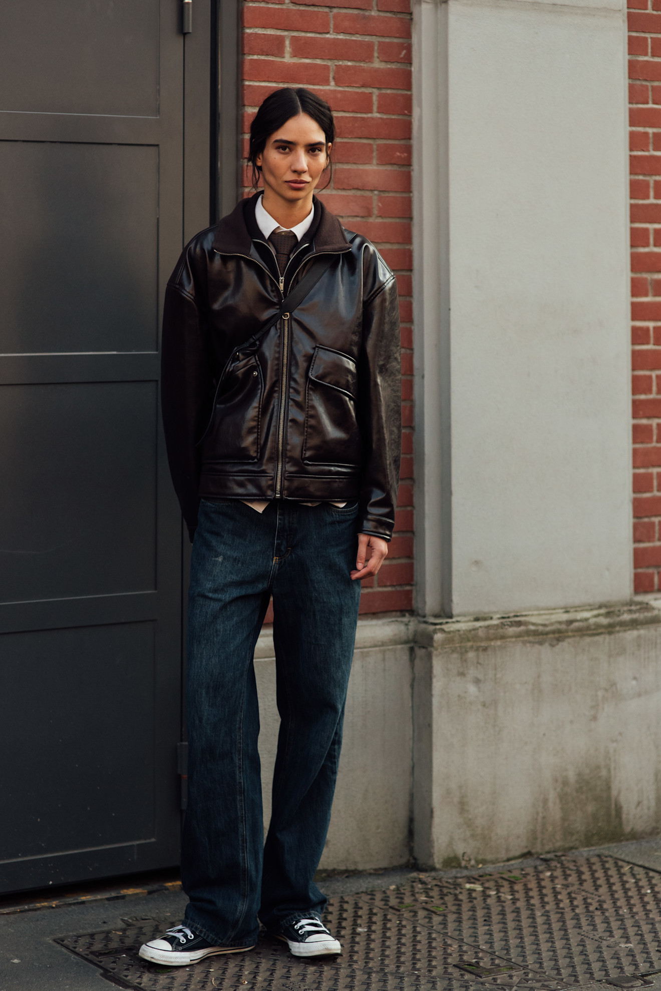 Model wears a leather bomber jacket at Milan Fashion Week