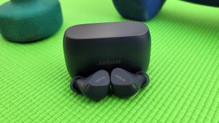 The Jabra Elite 4 Active displayed on a yoga mat