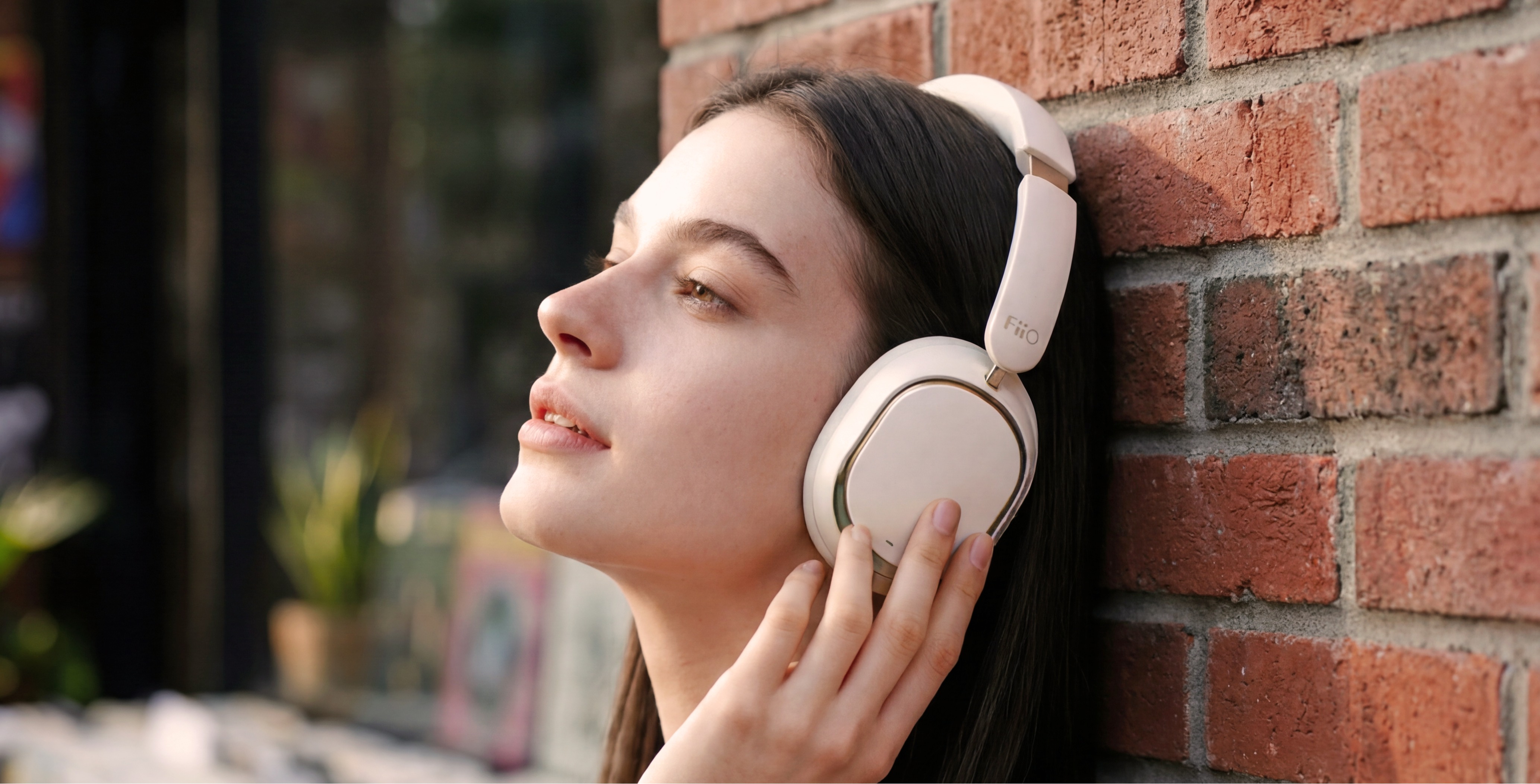 FiiO EH13 wireless headphones worn being worn by a woman