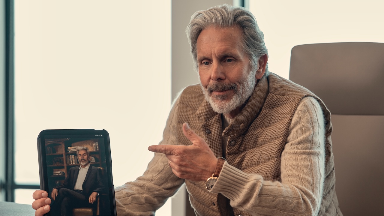 Gary Cole pointing to a picture of himself in A Man on the Inside Season 2