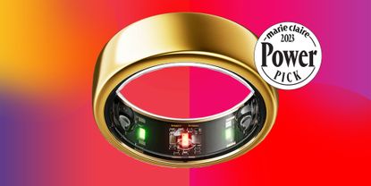 A gold ring with black and green lights and circuitry within the band