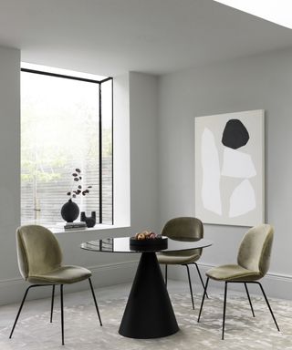 Dining room with white walls and monochromatic furniture