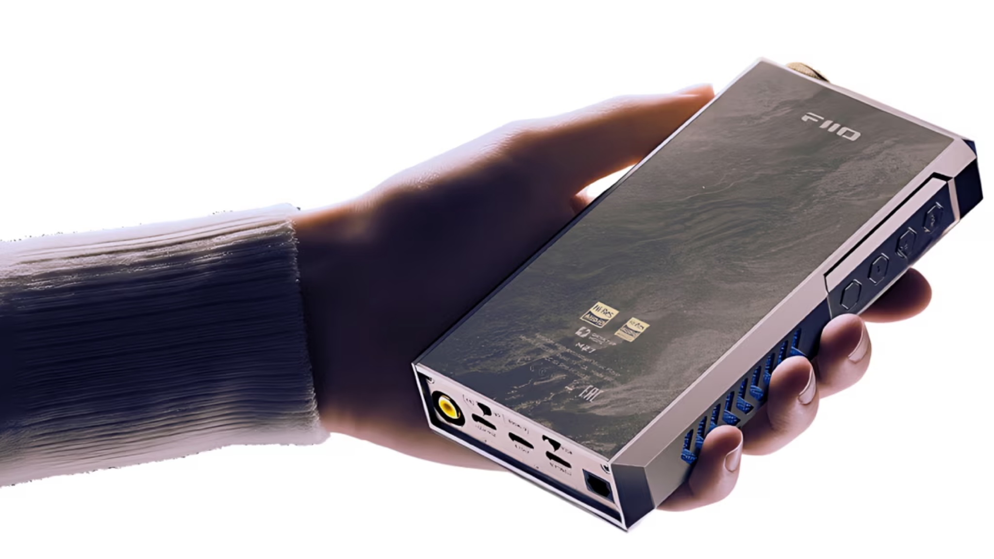 A hand holds the FiiO M27 portable music player in front of a white background