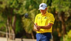 Sergio Garcia lines up a putt with a yellow Fireballs polo on