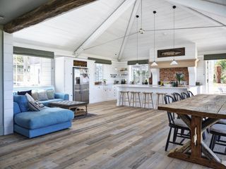 open plan white kitchen with vaulted ceiling