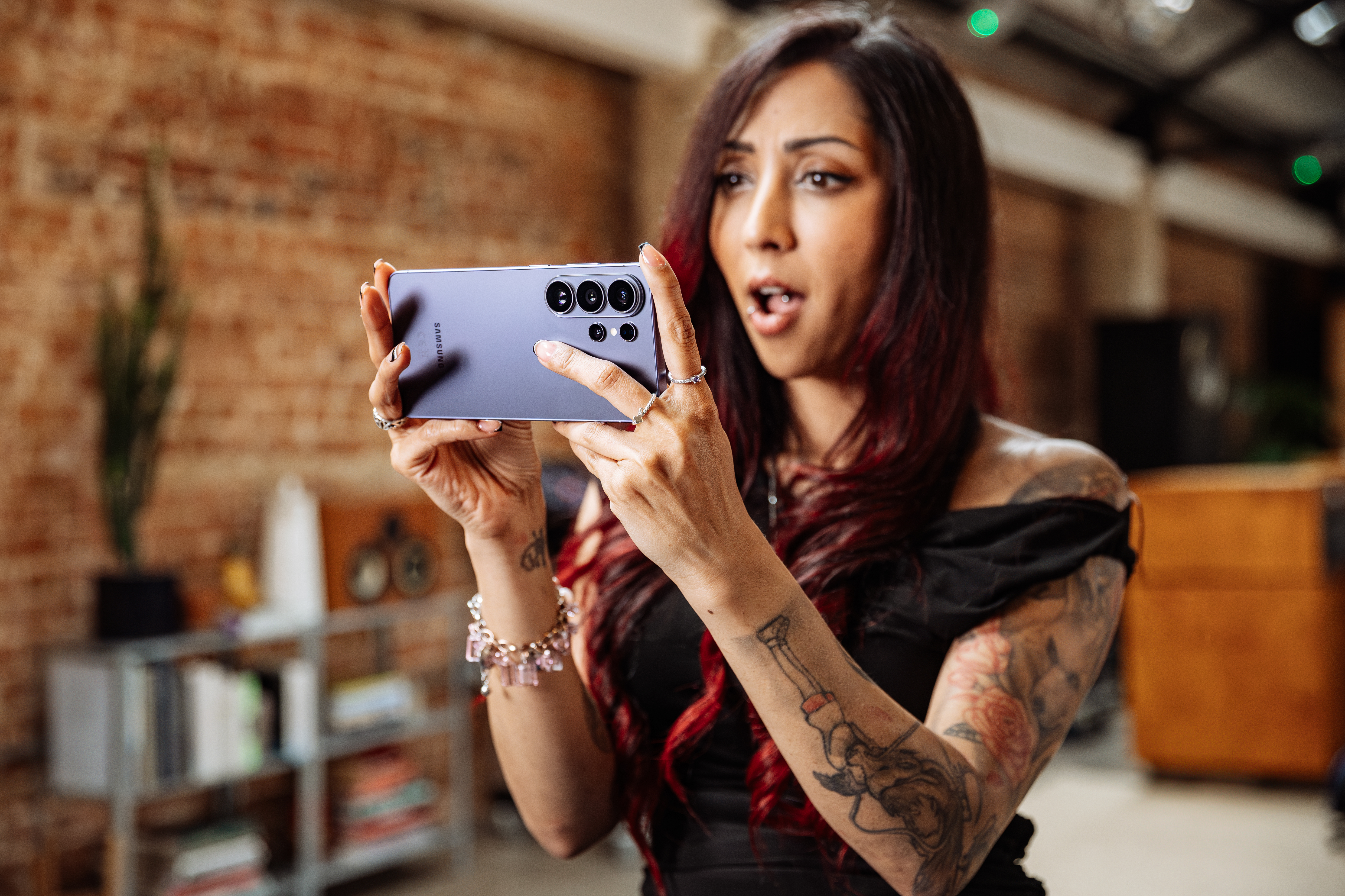 A woman plays a game on her Samsung Galaxy S26 Ultra phone