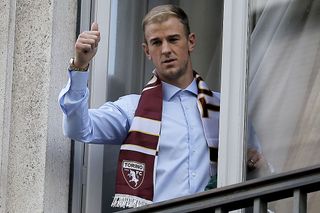 British goalkeeper Joe Hart poses with a supporter shirt upon his arrival for a medical check before joining the Torino football club from former club Manchester City on August 30, 2016 in Turin. England goalkeeper Joe Hart arrived in Turin on Agust 30 ahead of undergoing a medical that should see him sign a season-long loan deal with the unfashionable Serie A club. Hart, 29, has fallen out of favour with Pep Guardiola at Manchester City following the signing of Claudio Bravo from Barcelona and is set to join Torino in a bid to preserve his club future and international career following England's spectacular Euro 2016 exit.