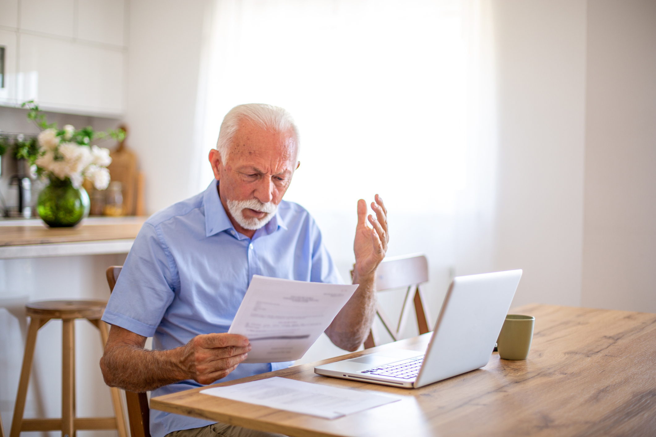 a pic of a man surprised reading a bill
