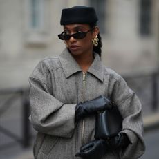 a woman wears a pillbox hat