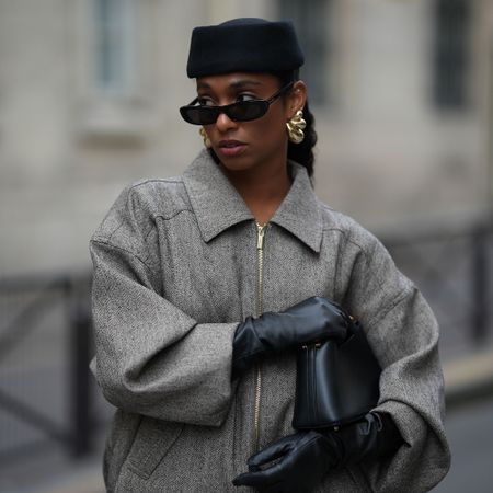 a woman wears a pillbox hat