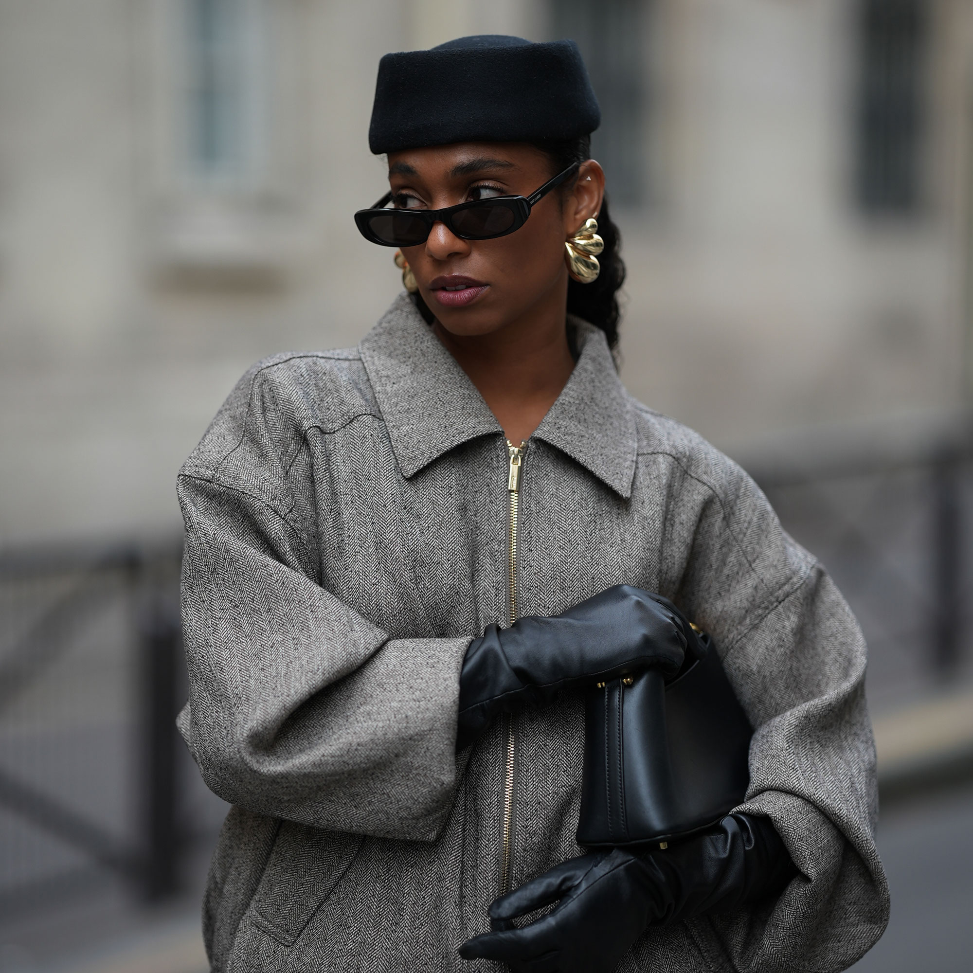 a woman wears a pillbox hat