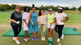 Coach Shayain and female golfers