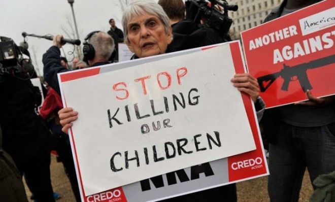 A protester demonstrates in front of the NRA lobbying offices in Washington, D.C., on Dec. 17.