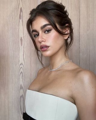 Kaia Gerber with untied updo