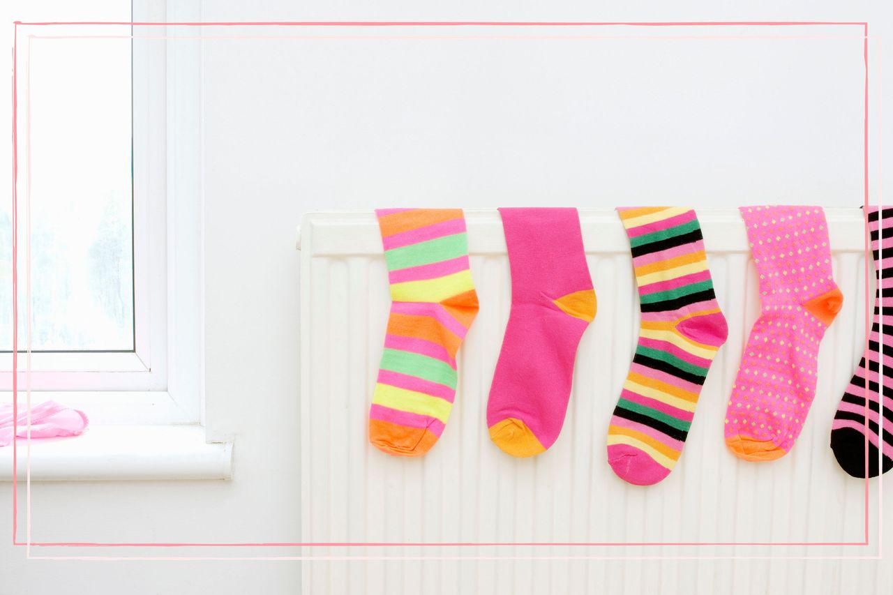 How to dry clothes without a dryer as illustrated by socks hanging on a radiator