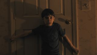 Alex (Cary Christopher) blocking a door in Weapons