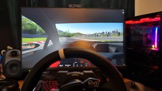 A drivers eye-view of the MOZA R5 being used for some sim racing, with a terrible driver behind the wheel